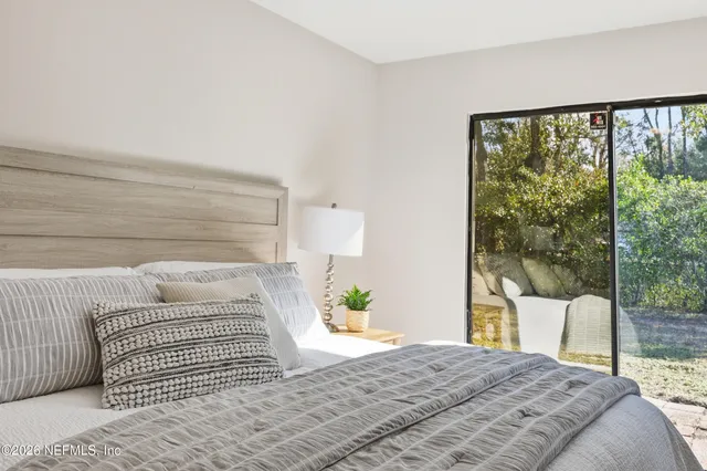 a bedroom with a large bed and a window