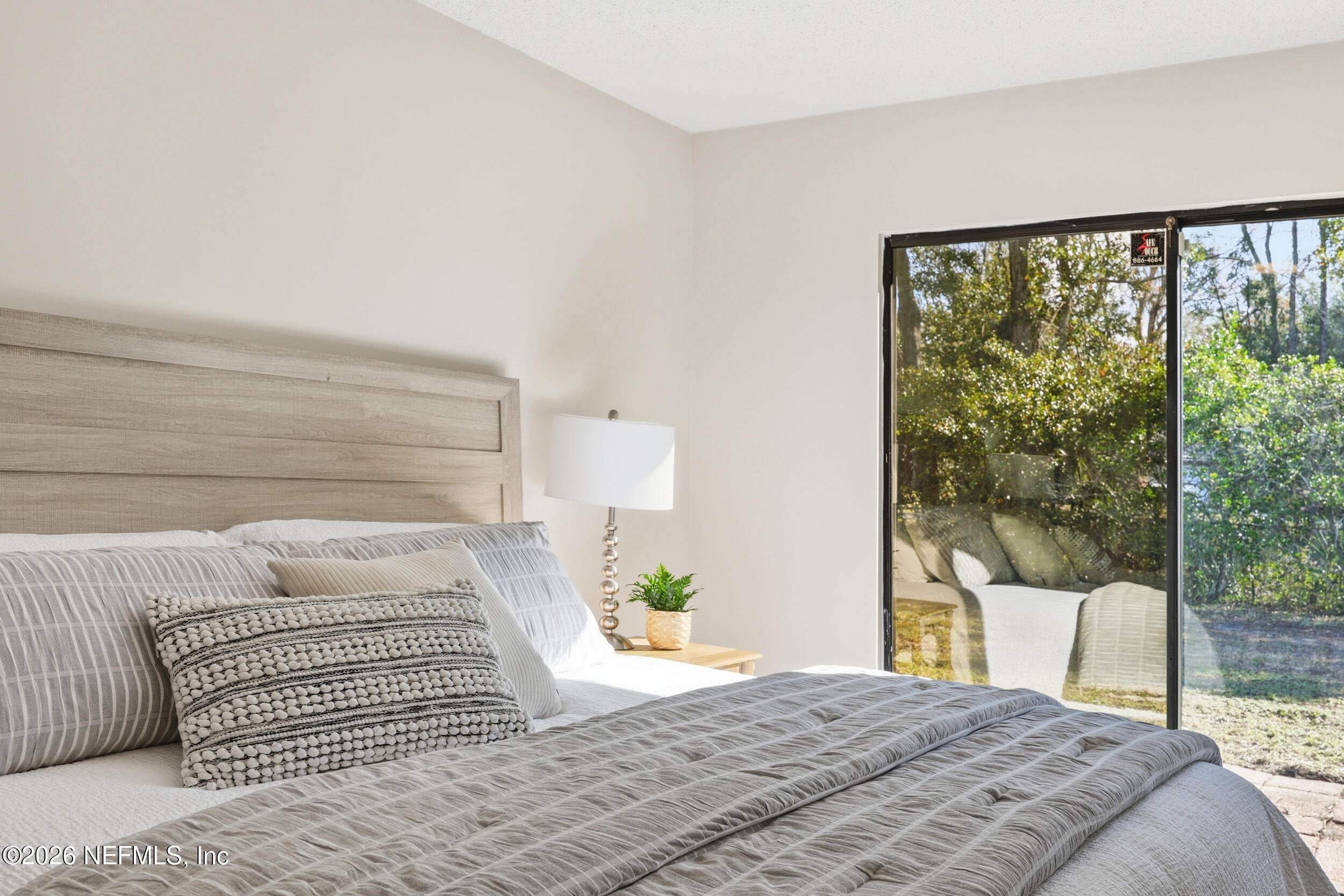 2171 Carter Braxton Road Orange Park, FL 32073 - Photo 7 of 39 a bedroom with a large window and a bed