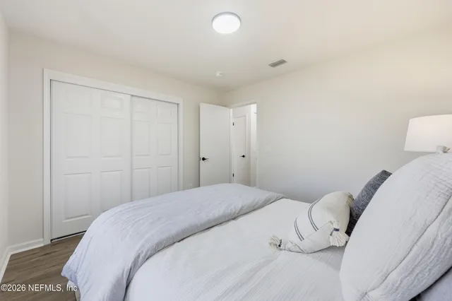 a bedroom with a bed and a lamp