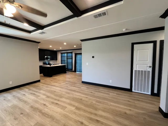 a view of kitchen with refrigerator and window