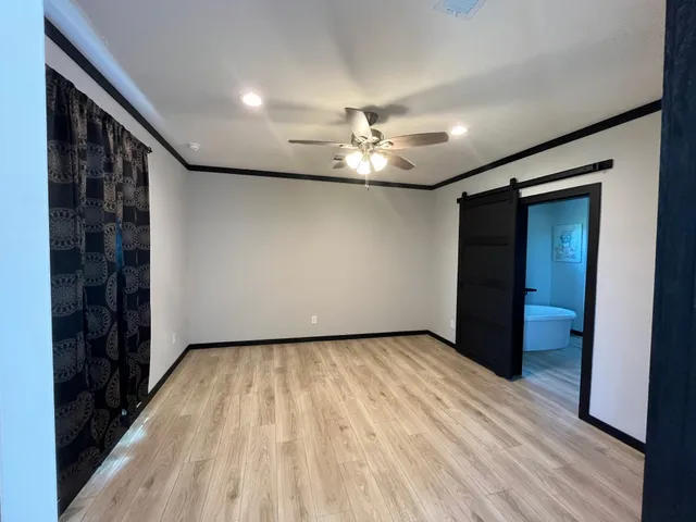 a view of empty room with wooden floor