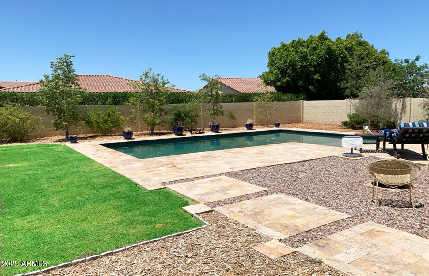 4836 South Covalent Lane Mesa, AZ 85212 - Photo 12 of 66 a view of a swimming pool with a patio and a garden