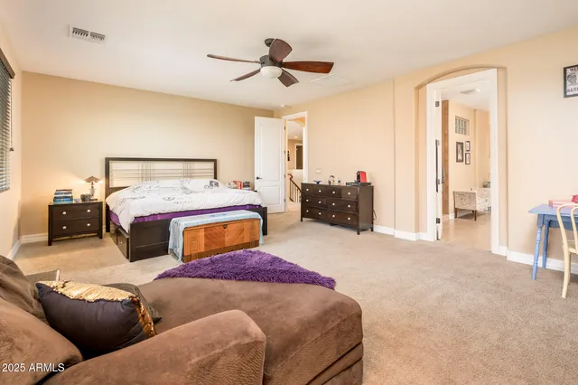 a living room with furniture and a ceiling fan