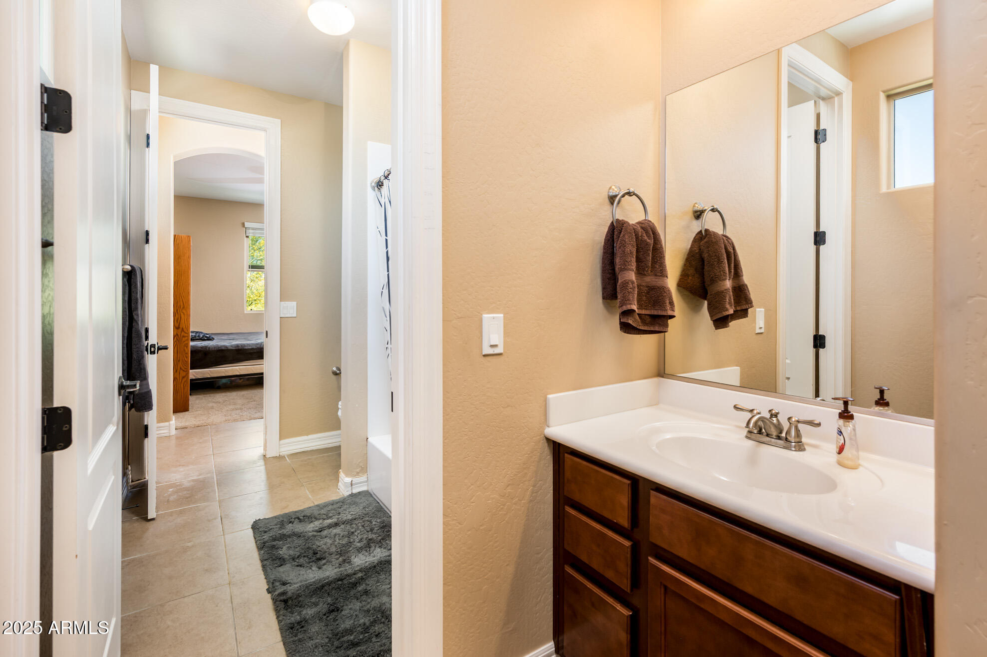 4836 South Covalent Lane Mesa, AZ 85212 - Photo 41 of 66 a en suite bathroom with a sink and mirror