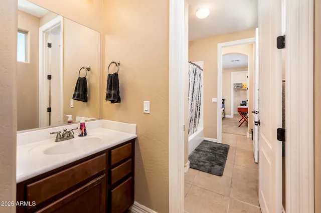 a bedroom with a bed and a desk