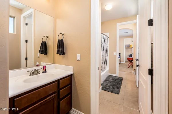 a utility room with dryer washer and a view of living room