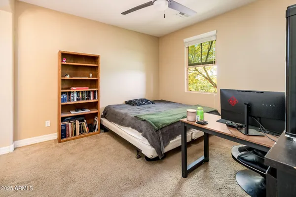 a bedroom with a bed and a desk