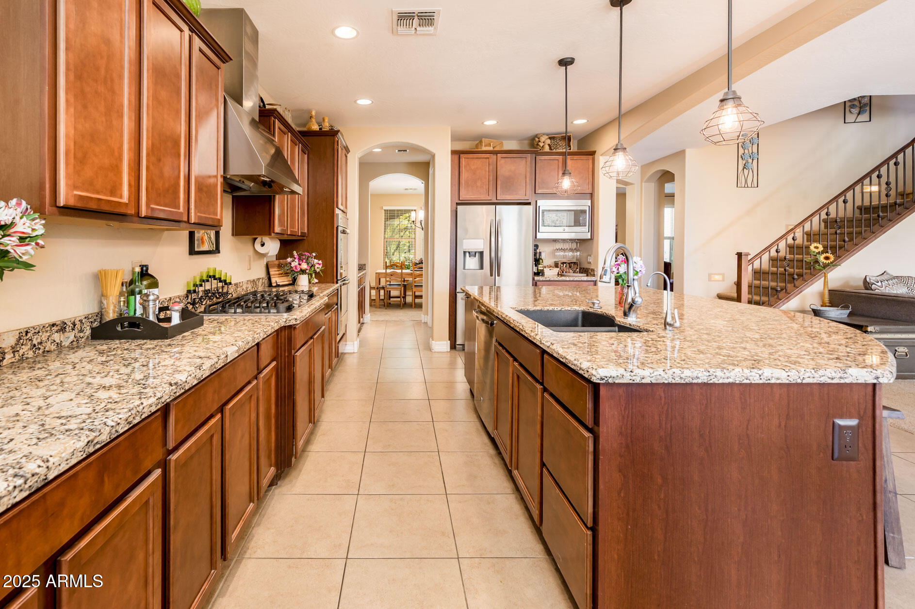 4836 South Covalent Lane Mesa, AZ 85212 - Photo 8 of 66 a kitchen with kitchen island granite countertop a sink and a refrigerator