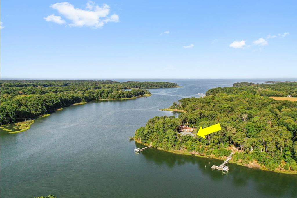 13581 Solitude Trail Machipongo, VA 23405 - Photo 1 of 51 a view of a lake with a big yard