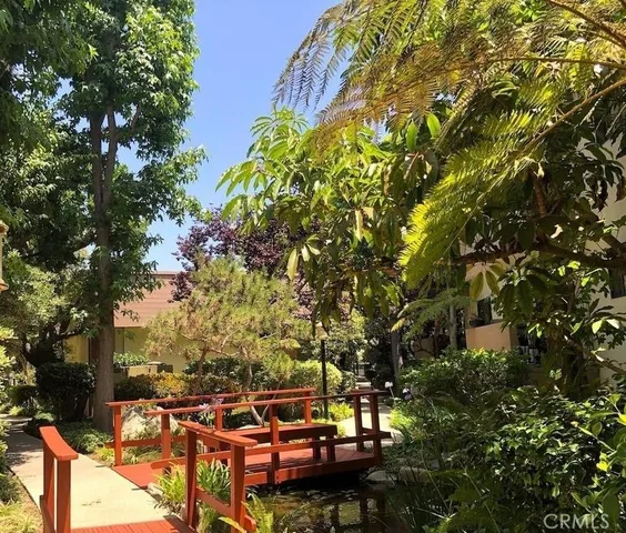 an aerial view of a house with garden space and trees