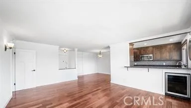 a view of empty room with wooden floor and fireplace
