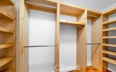 a view of walk in closet with empty racks