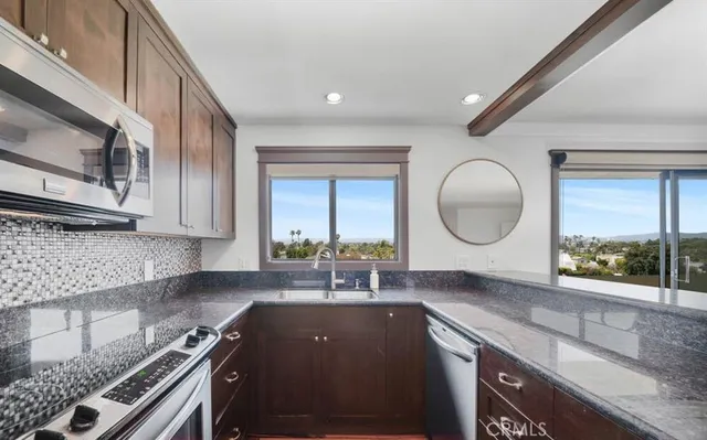 a kitchen with a sink cabinets and window