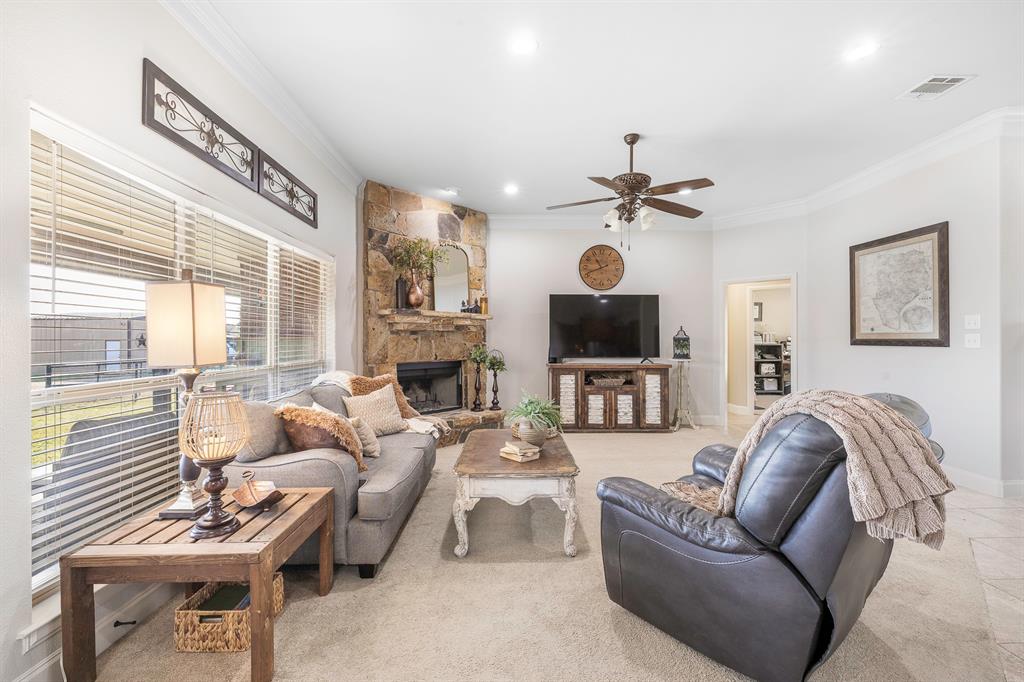 116 Miramar Circle Weatherford, TX 76085 - Photo 10 of 37 Living room featuring ornamental molding, a fireplace, recessed lighting, and a ceiling fan