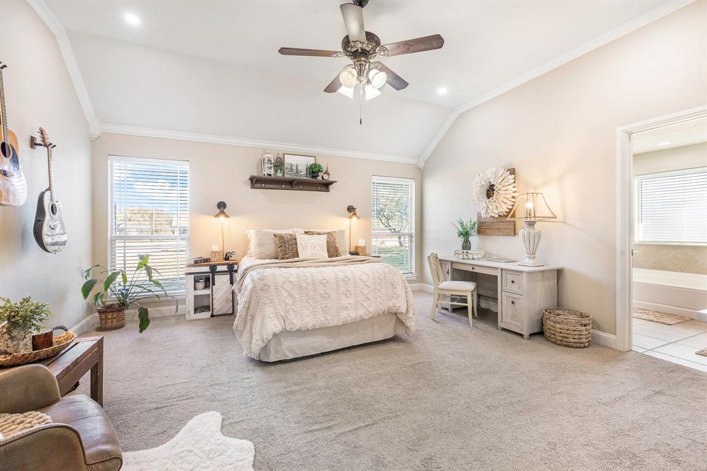 116 Miramar Circle Weatherford, TX 76085 - Photo 11 of 37 Bedroom featuring vaulted ceiling, multiple windows, carpet floors, ceiling fan, and ornamental molding