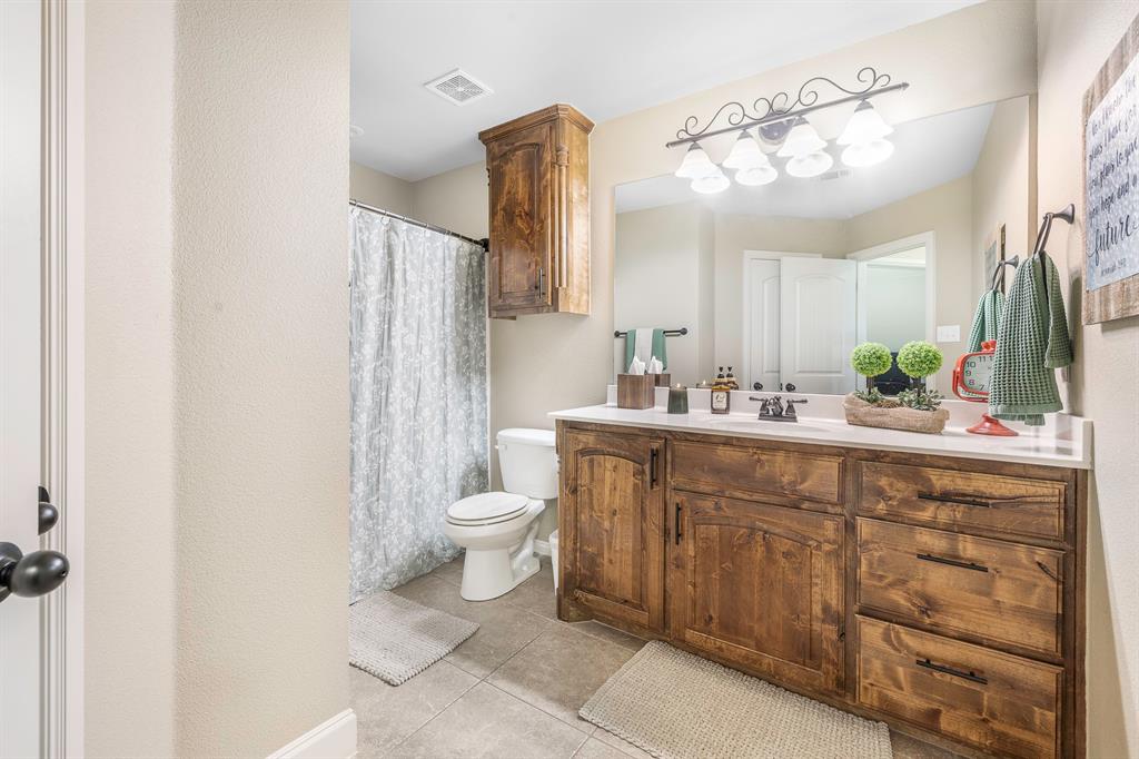 116 Miramar Circle Weatherford, TX 76085 - Photo 20 of 37 Guest bathroom featuring a shower/tub, large vanity and cabinets that match kitchen and primary bath