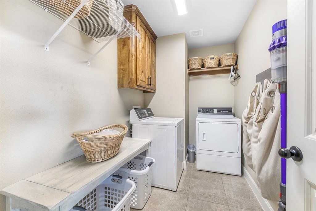 116 Miramar Circle Weatherford, TX 76085 - Photo 21 of 37 Laundry room with cabinet space, separate washer and dryer, and light tile patterned floors