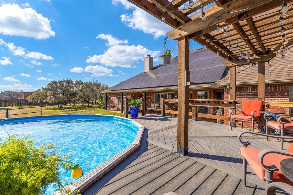 116 Miramar Circle Weatherford, TX 76085 - Photo 29 of 37 Swimming pool with composite deck and cedar pergola with lights