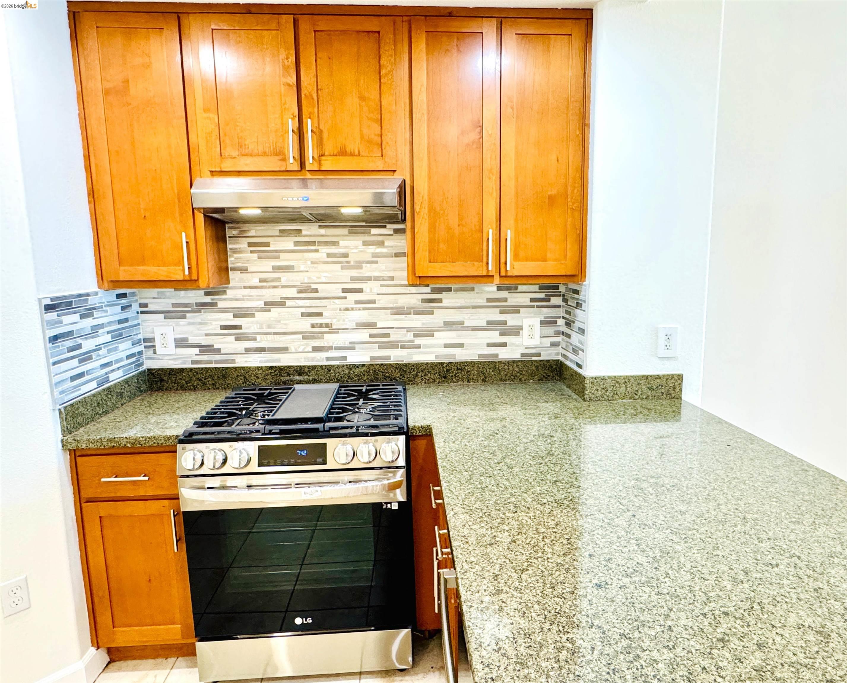 423 7th Street, Unit 303 Oakland, CA 94607 - Photo 11 of 19 a kitchen with a stove and a sink