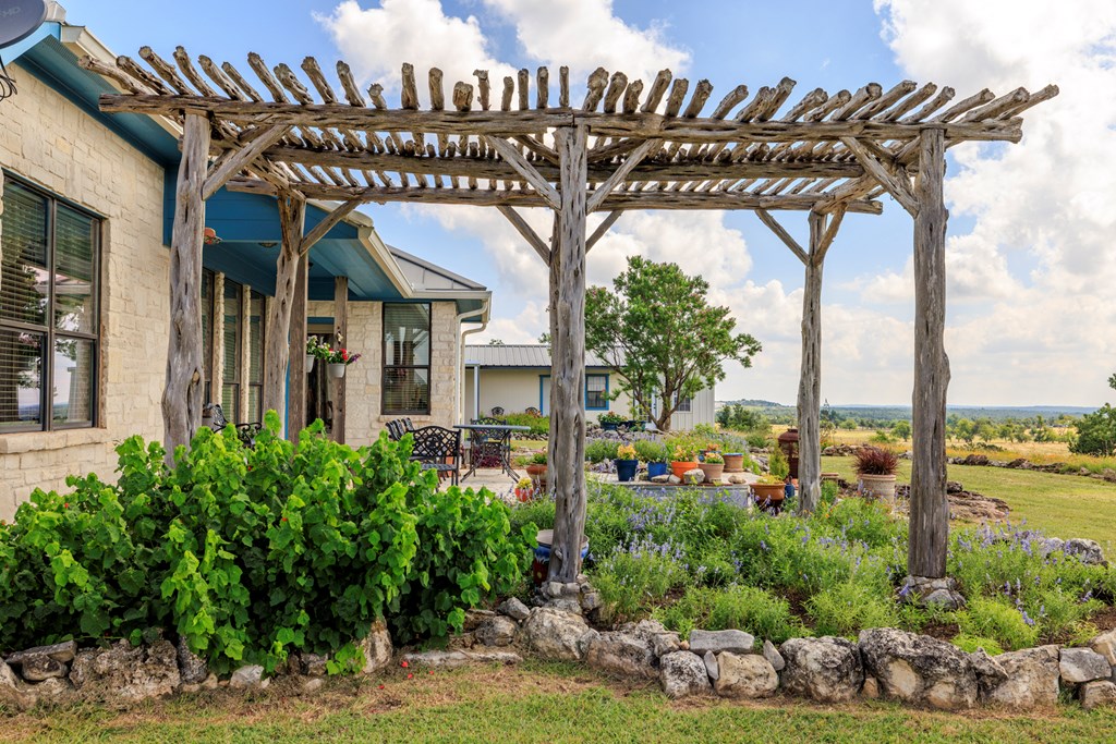 564 Gypsum Mine Road Fredericksburg, TX 78624 - Photo 19 of 20 a view of a house with a flower garden