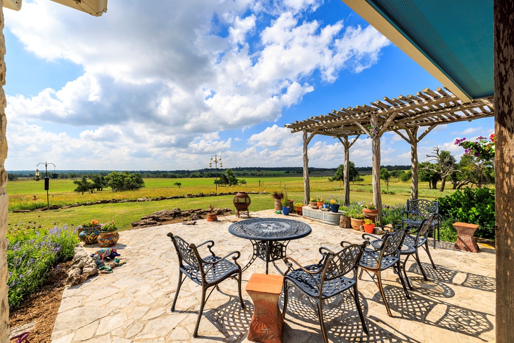 564 Gypsum Mine Road Fredericksburg, TX 78624 - Photo 20 of 20 a view of swimming pool with outdoor seating and a ocean view