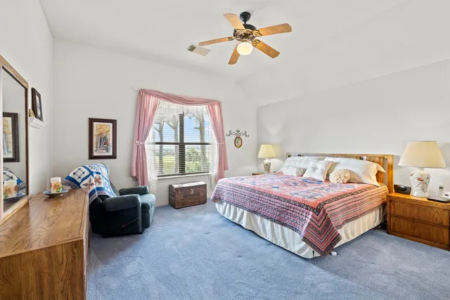 a spacious bedroom with a bed and a couch