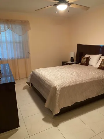 a bedroom with a bed and a night stand