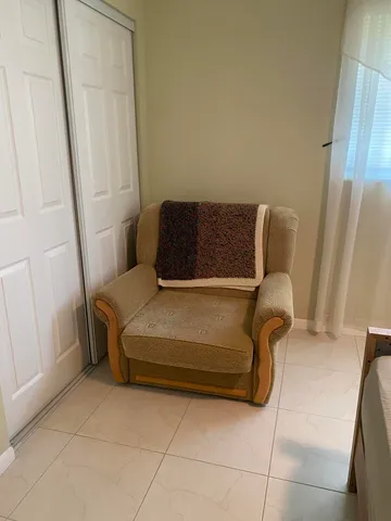 a bedroom with a couch and a window