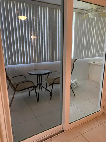 a balcony with table and chairs