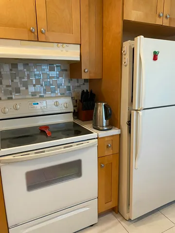 a white refrigerator freezer sitting inside of a kitchen
