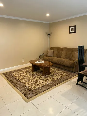 a living room with a couch and a rug