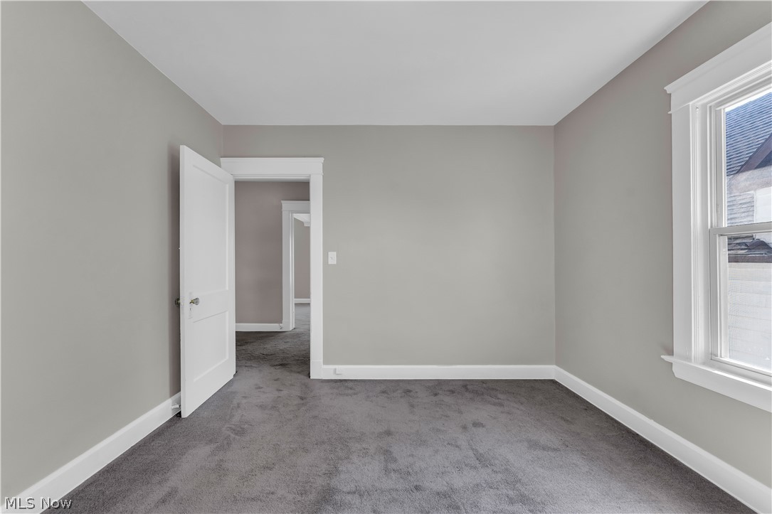 3506 Riverside Avenue Cleveland, OH 44109 - Photo 17 of 31 Interior room featuring neutral gray wall paint, dark gray carpeting, and white baseboards