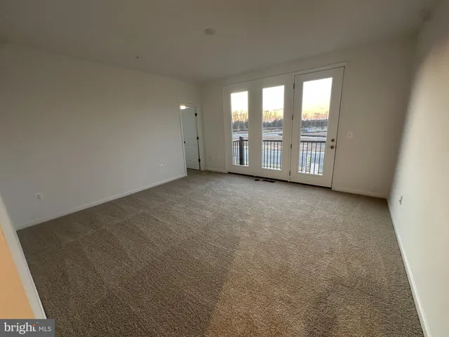 a view of an empty room with windows and city view