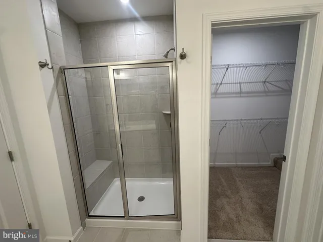 a bathroom with a glass shower door