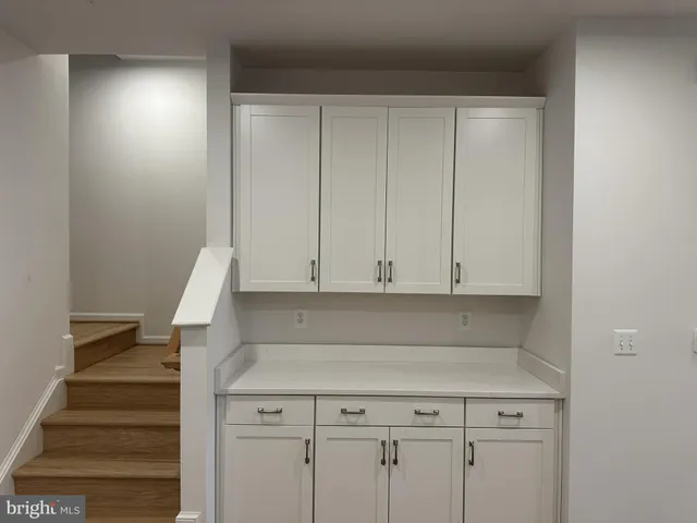 a view of room with stairs and wooden floor
