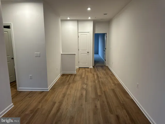 a view of hallway with wooden floor