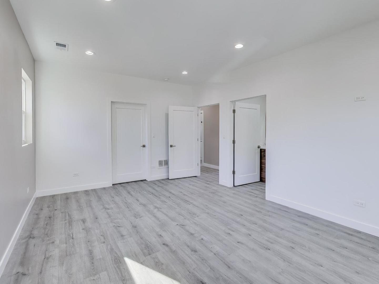 1721 West Arthur Avenue Chicago, IL 60626 - Photo 11 of 26 a view of an empty room with wooden floor
