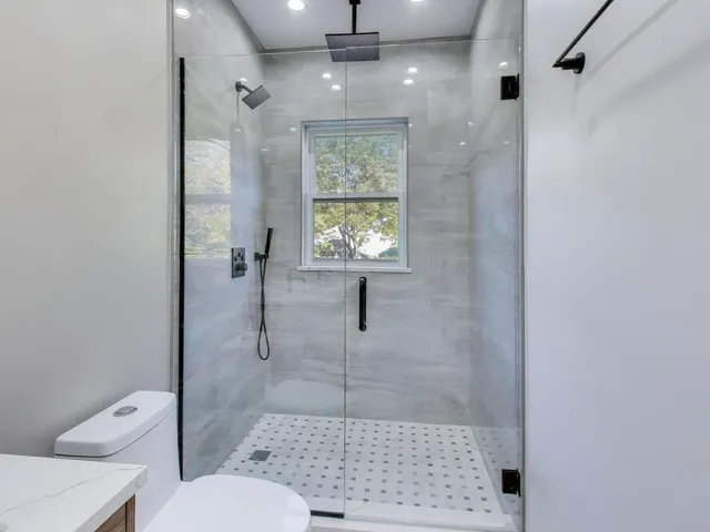 a bathroom with a shower toilet and a sink