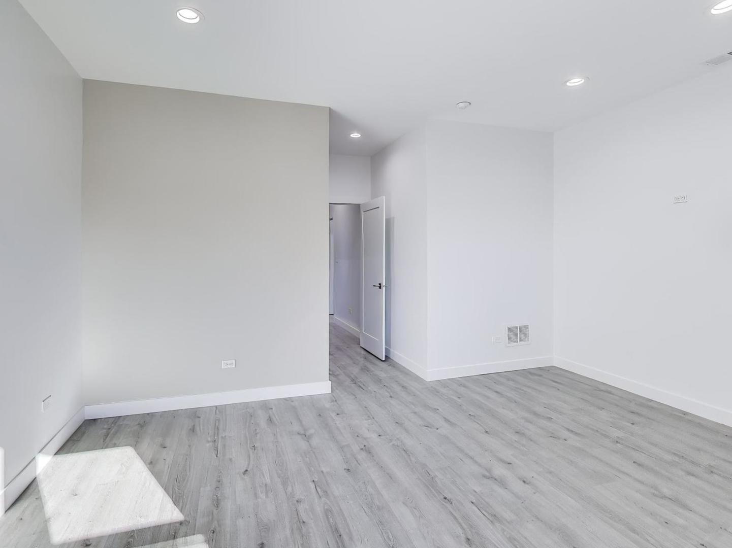 1721 West Arthur Avenue Chicago, IL 60626 - Photo 15 of 26 a view of an empty room with wooden floor and a window