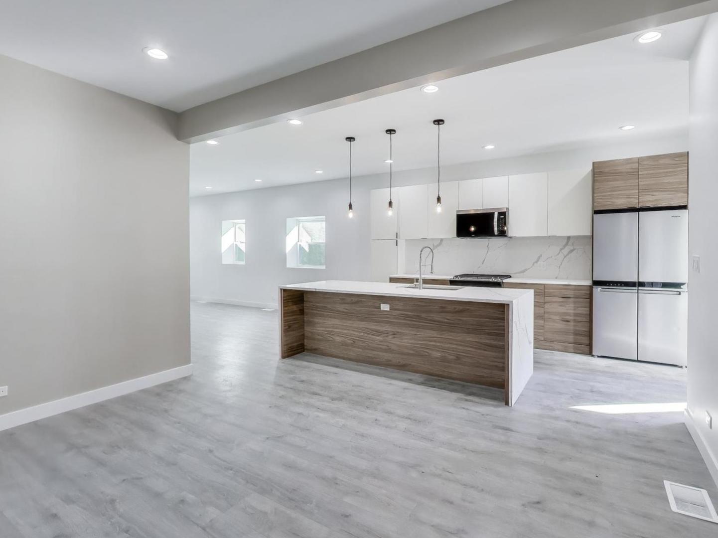 1721 West Arthur Avenue Chicago, IL 60626 - Photo 5 of 26 a large kitchen with kitchen island a sink stainless steel appliances and cabinets