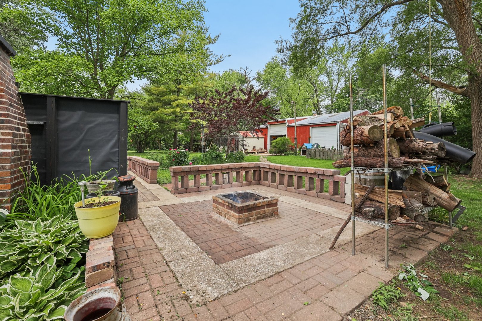 20214 Harmony Road Marengo, IL 60152 - Photo 30 of 56 a view of a patio with table and chairs and wooden fence