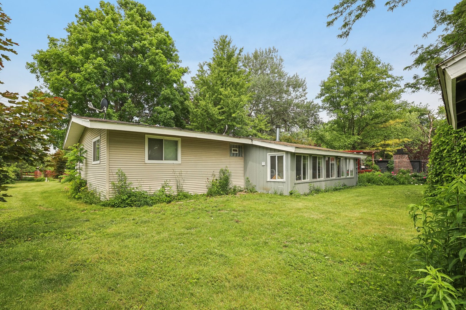 20214 Harmony Road Marengo, IL 60152 - Photo 34 of 56 a view of a backyard with plants and large tree