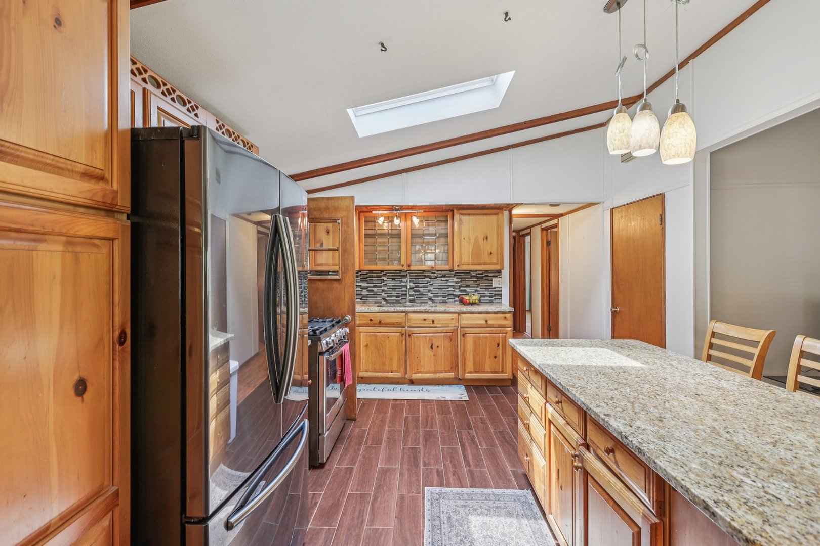 20214 Harmony Road Marengo, IL 60152 - Photo 9 of 56 a kitchen with stainless steel appliances granite countertop a refrigerator and wooden floor