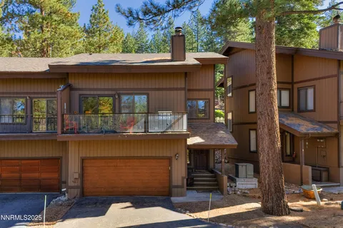a front view of a house with basket ball court and outdoor seating