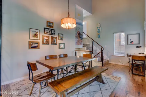 a dining room with furniture and wooden floor