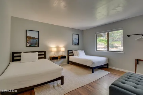 a bedroom with a bed a couch and a window