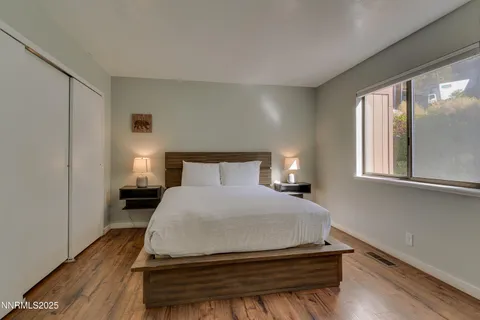 a bedroom with a bed and window