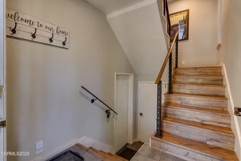 a view of entryway with stairs and wooden floor