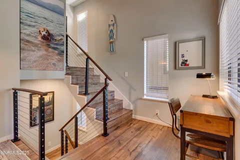 a view of entryway and hall with wooden floor