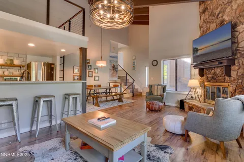 a living room with furniture a chandelier and a table